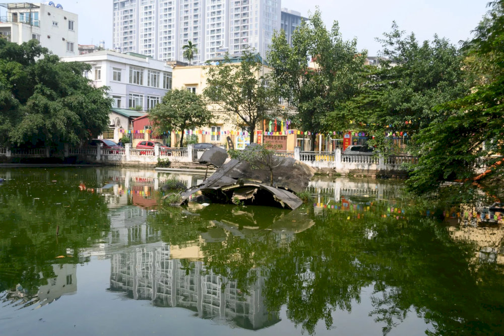 The peaceful Huu Tiep Lake with the historical B-52 bomber wreck lying quietly in the water